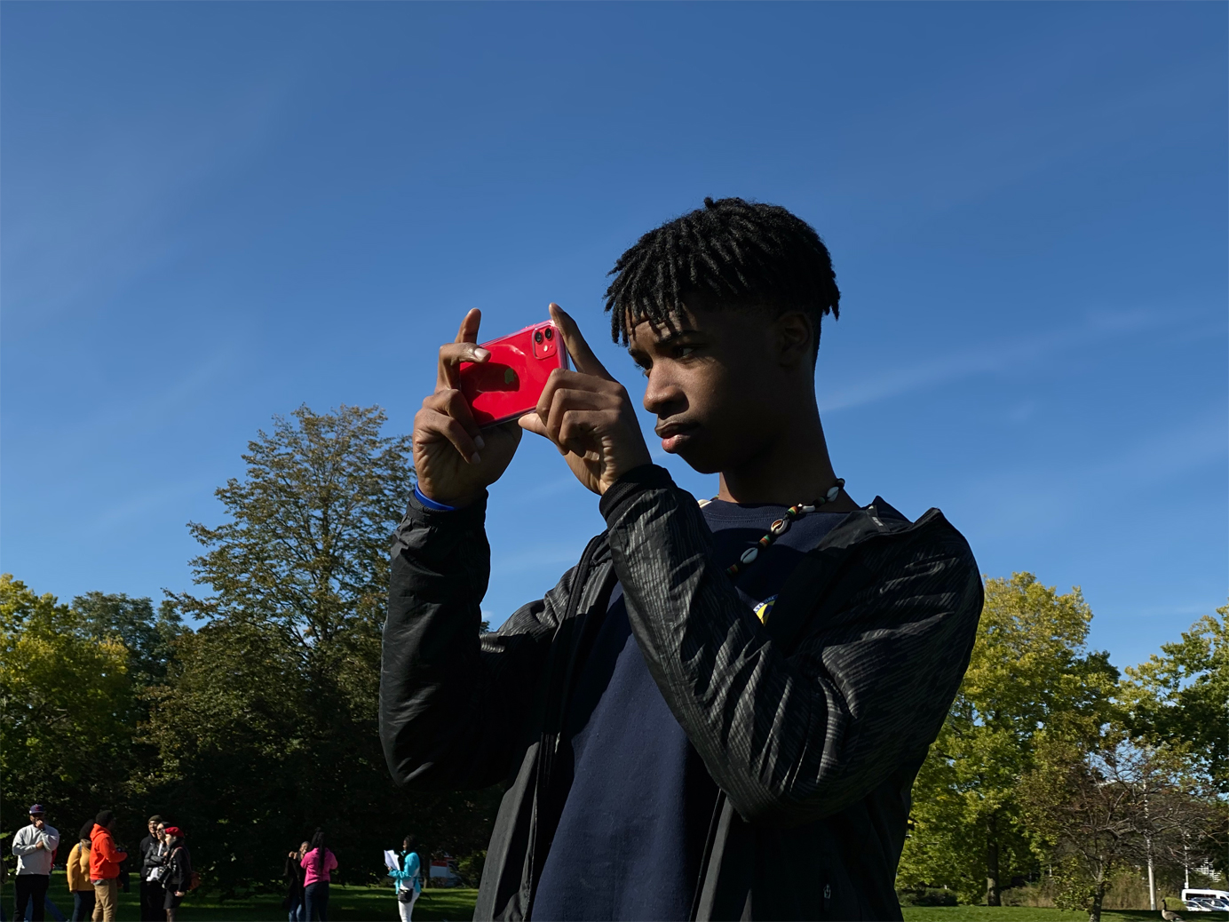 J takes a picture with iPhone 11.